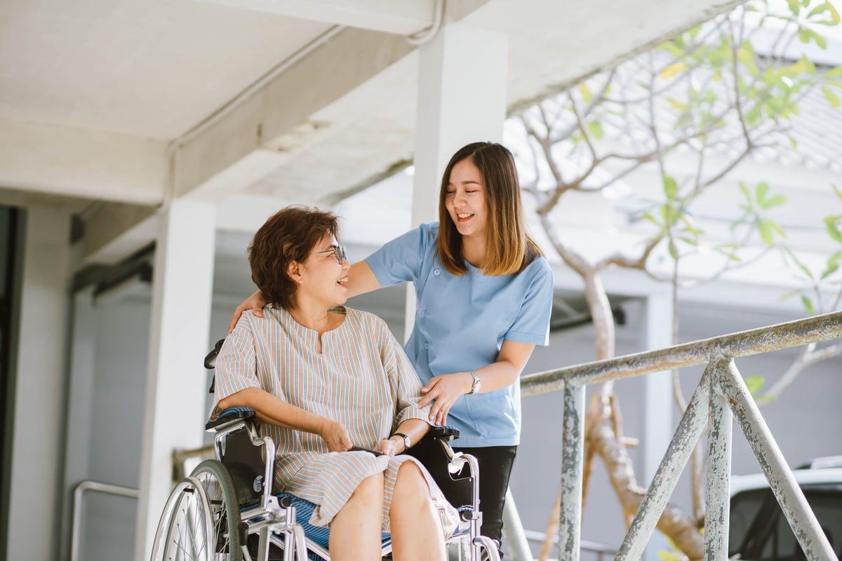 Physiotherapist Taking Care of the Senior Patient Outdoors